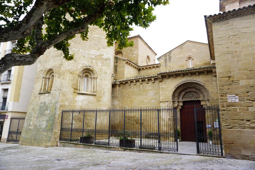 um edifício antigo com um portão em frente em Apartamento Huesca en Paseo Ramón y Cajal em Huesca