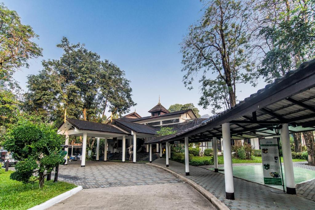 a pavilion at a park with a building at Supalai Pasak Resort Hotel And Spa in Kaeng Khoi