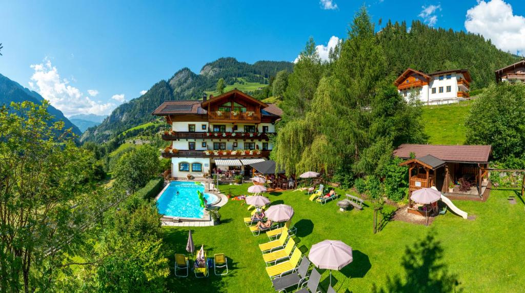 an aerial view of a resort with a swimming pool at Hotel Dorfer in Grossarl