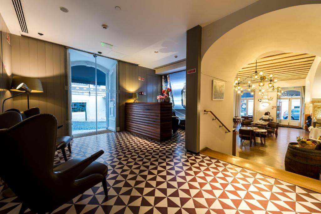 A patterned-floor lobby with reception, lounge seating and an arched dining area beyond.