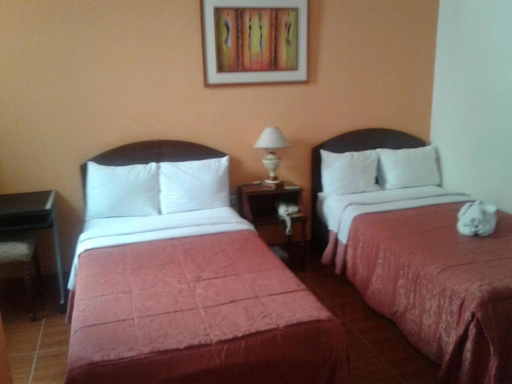Postel nebo postele na pokoji v ubytování Hotel Plaza Bolognesi 344