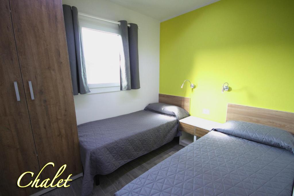Postel nebo postele na pokoji v ubytování Camping Santin