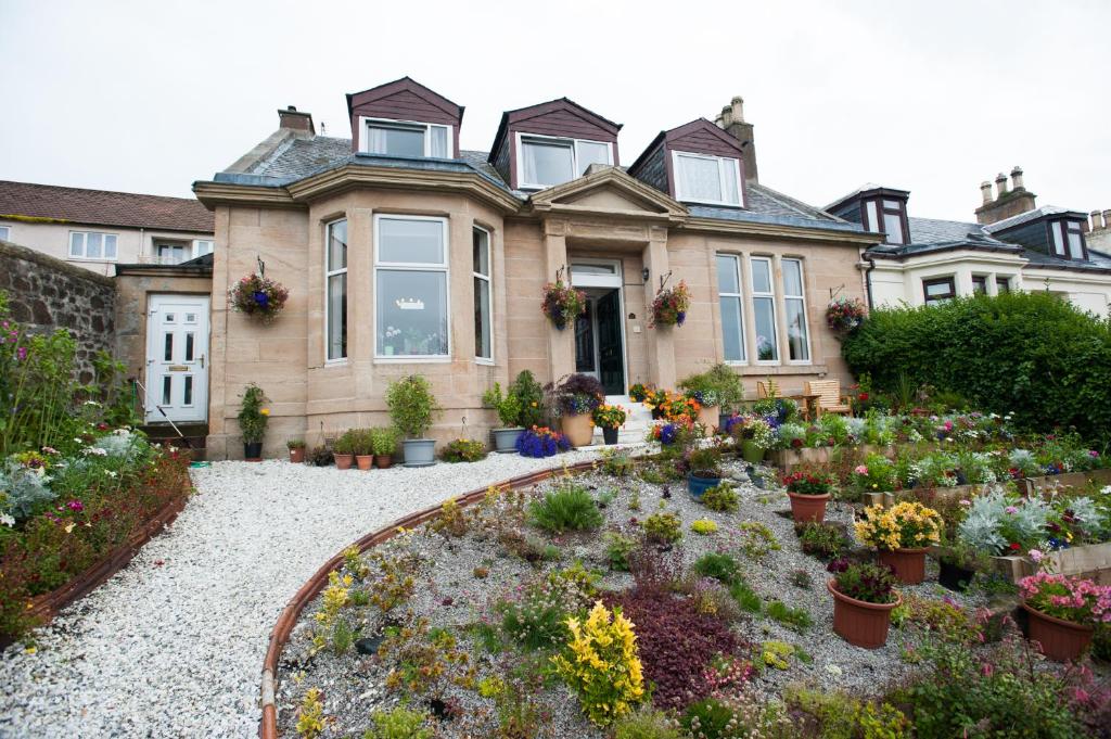 a house with a garden in front of it at Dean Park Guest House in Kilmarnock