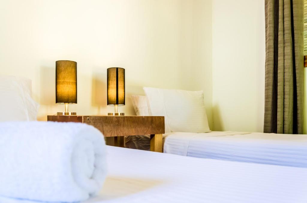 Postel nebo postele na pokoji v ubytování Amihan Bungalows