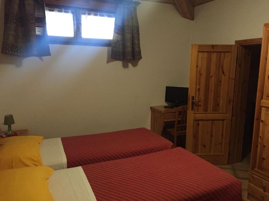 Voodi või voodid majutusasutuse Hotel Carrara toas