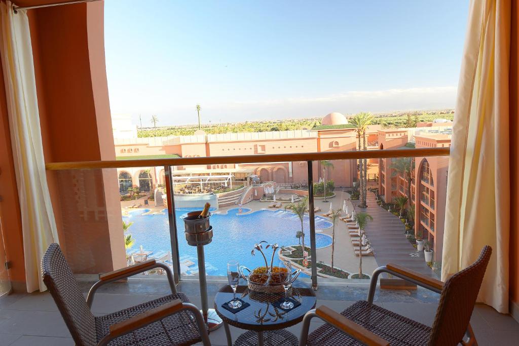 a view of a pool from a hotel room balcony at Savoy Le Grand Hotel Marrakech in Marrakesh