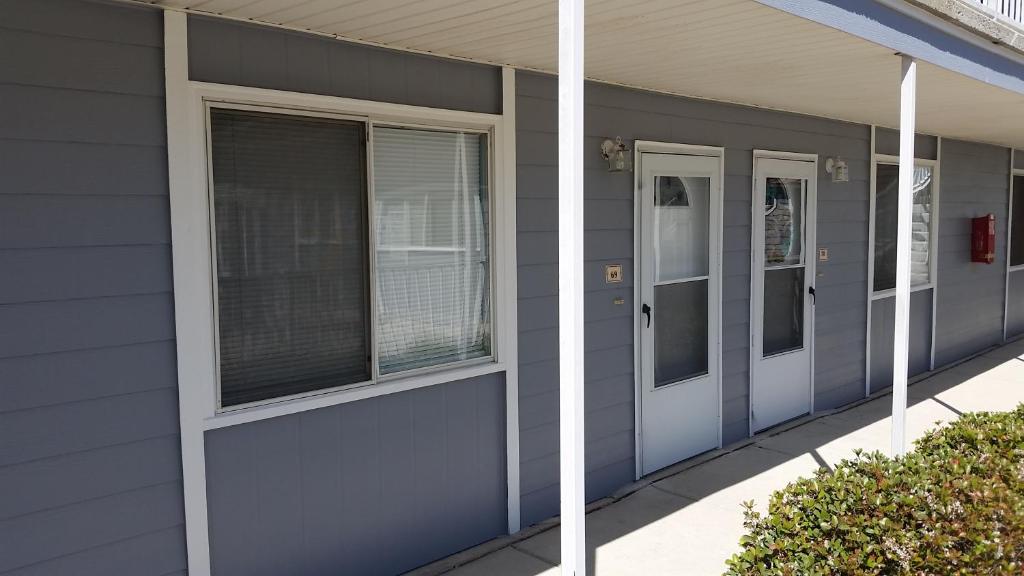 a gray building with two doors and windows at Beach Comber at Oak Shores in Biloxi