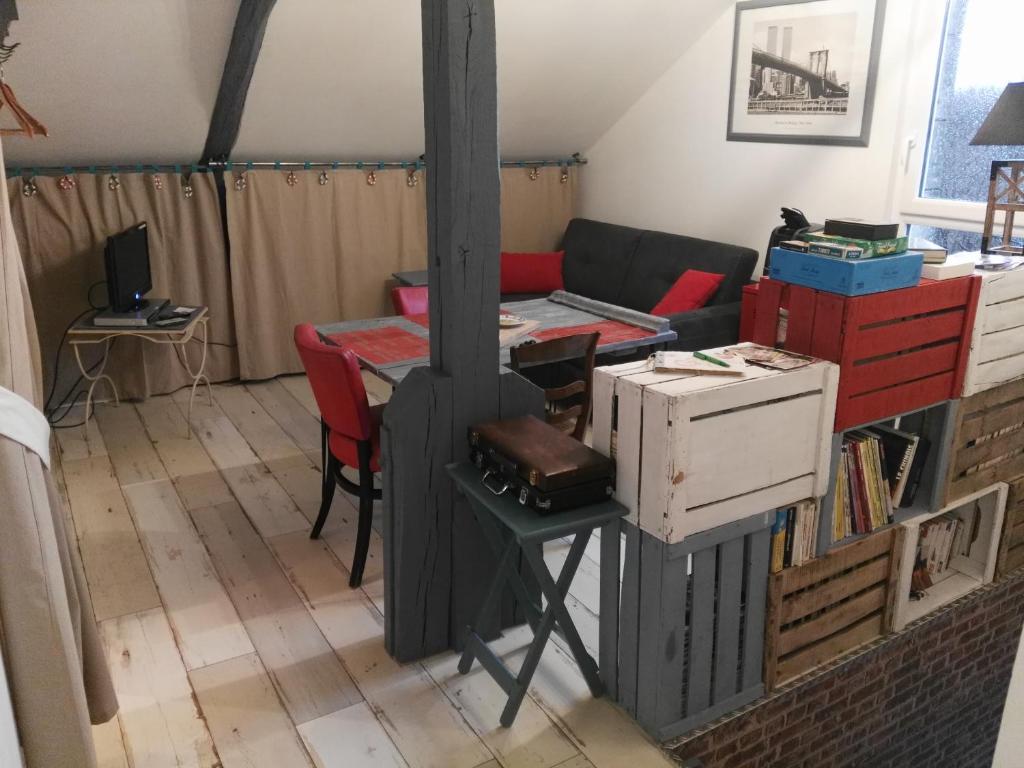 a living room with a stove and a couch at Le Grenier in Les Ageux