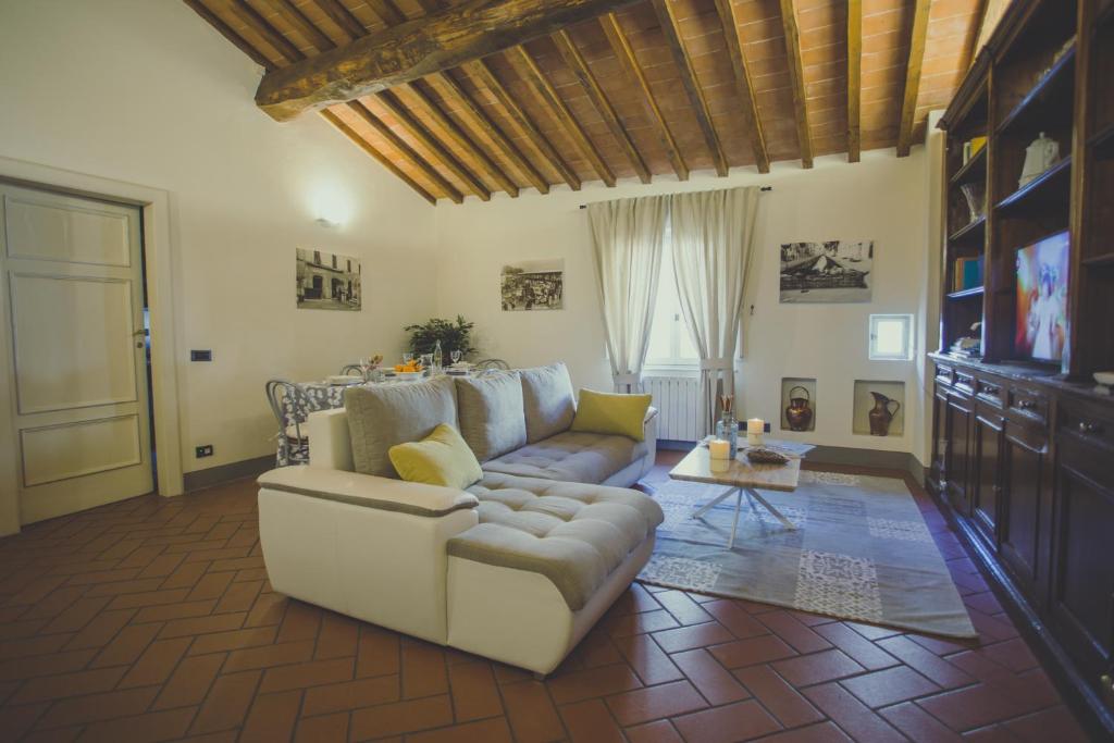 a living room with a couch and a table at Il Cuore Di Lucca in Lucca