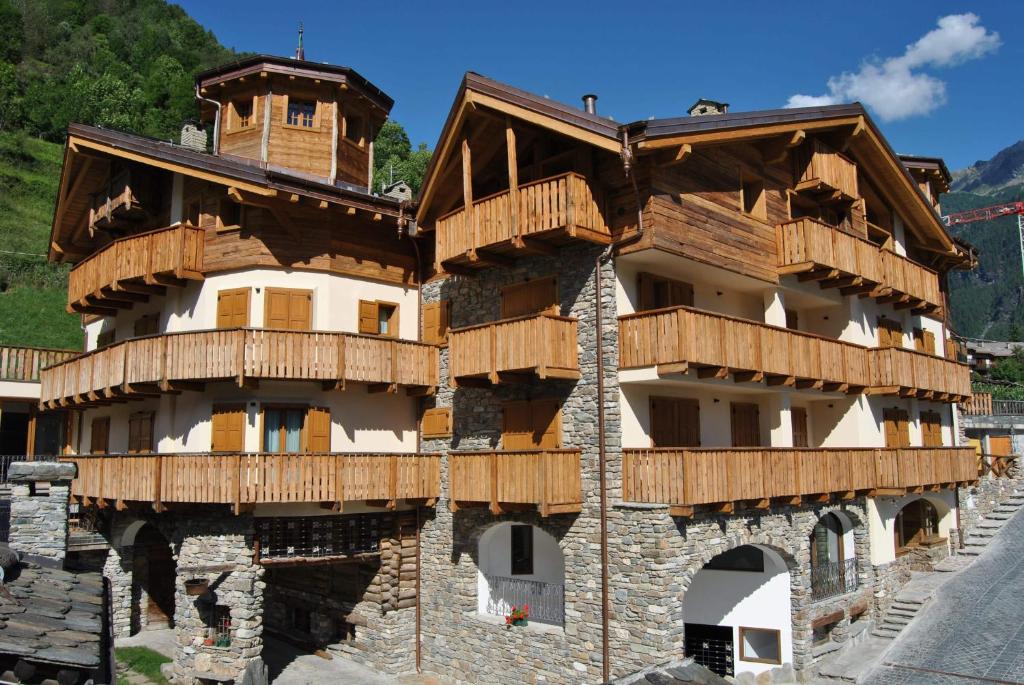a building with wooden balconies on the side of it at Casa Vacanza La Rocca in Chiesa in Valmalenco