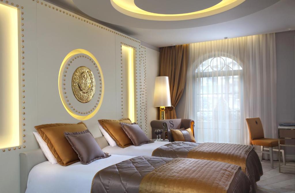 A bed or beds in a room at Sura Design Hotel & Suites