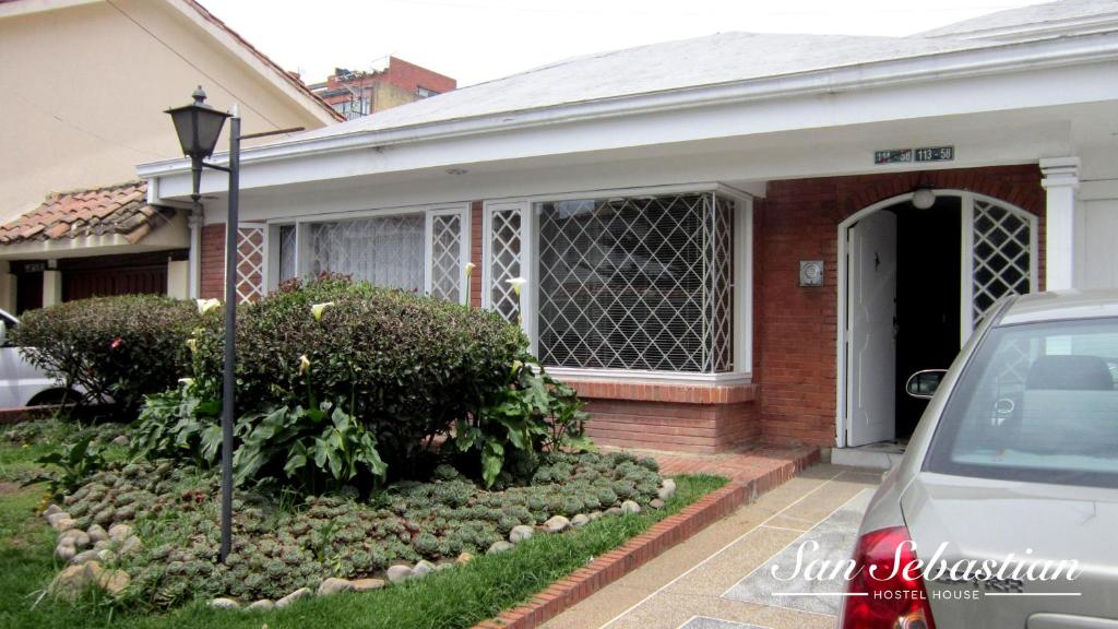 a house with a car parked in front of it at Casa Amanda B&B in Bogotá