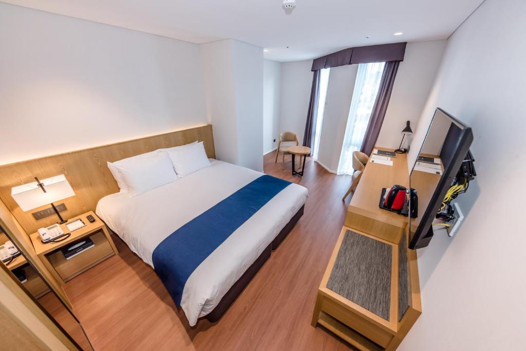 Postel nebo postele na pokoji v ubytování Hotel Sirius