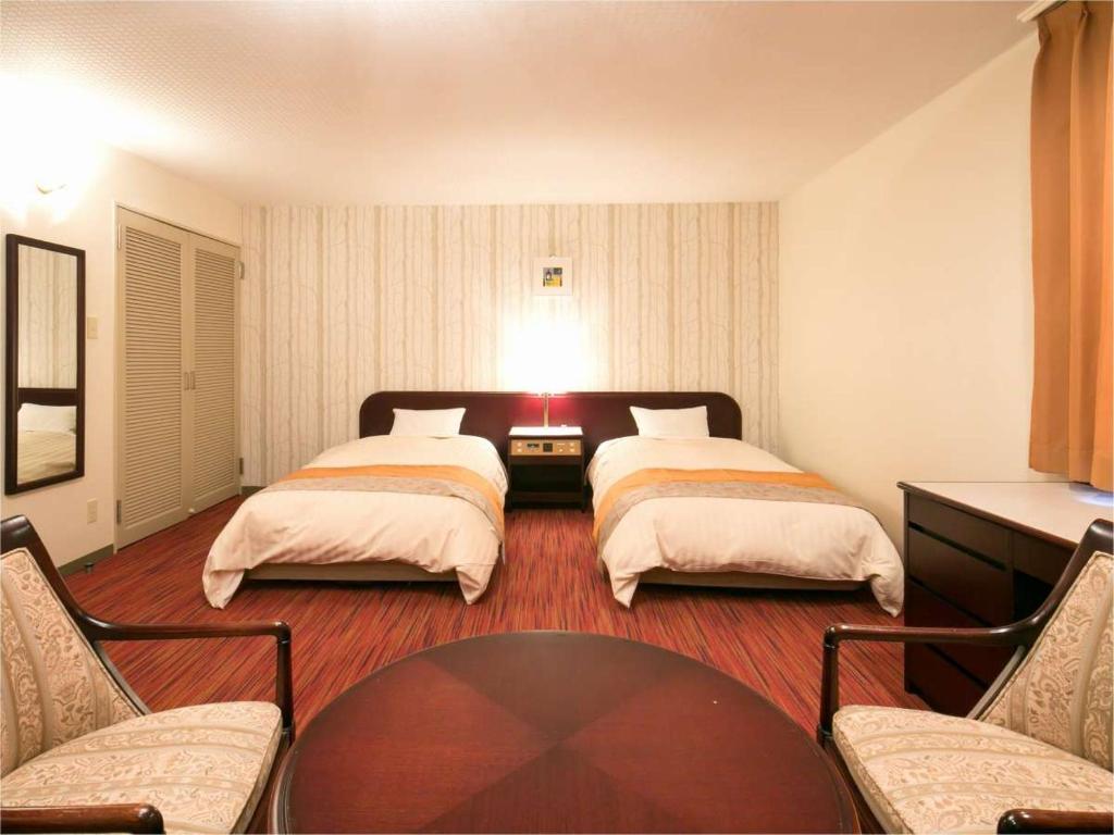 Postel nebo postele na pokoji v ubytování Azumino Hotaka View Hotel