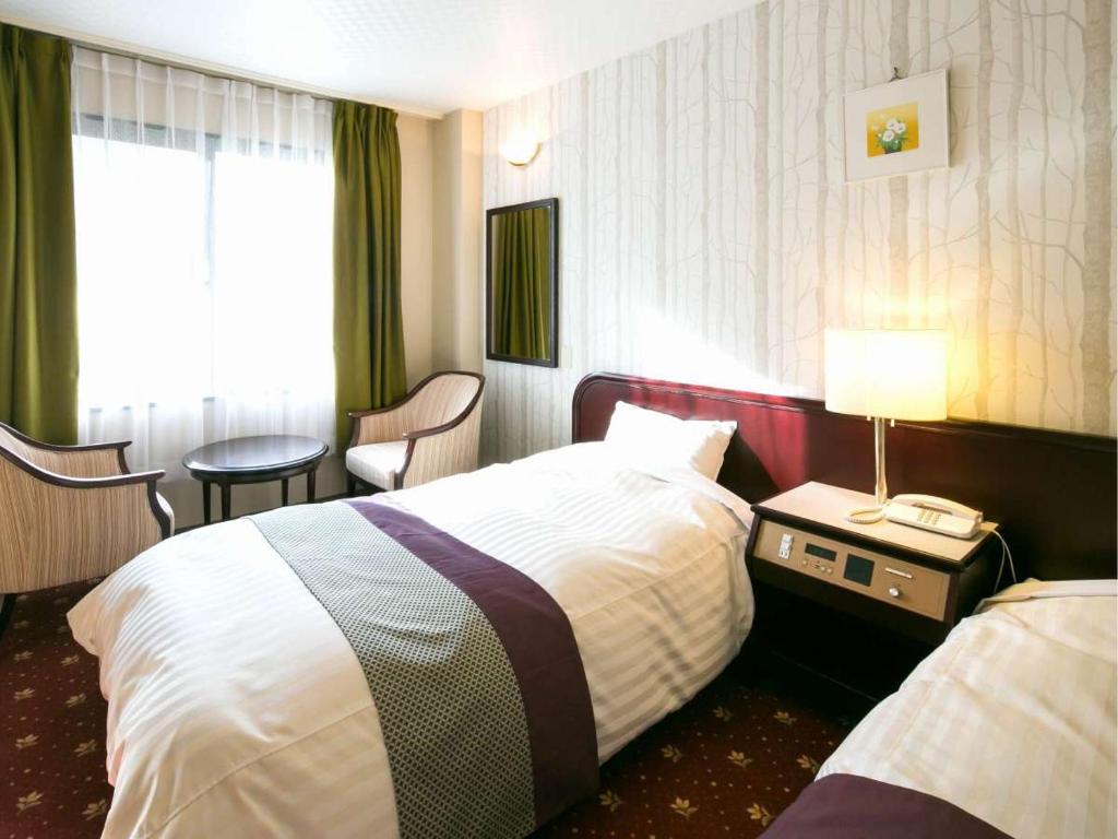 Postel nebo postele na pokoji v ubytování Azumino Hotaka View Hotel