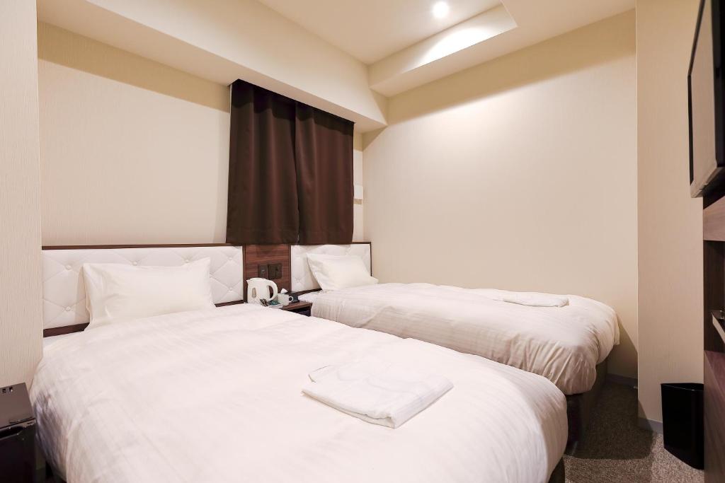 Postel nebo postele na pokoji v ubytování Welina Hotel Dotonbori