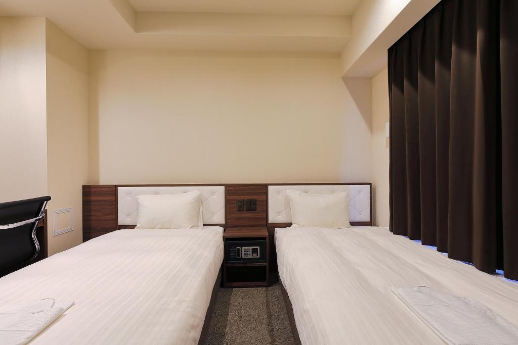Postel nebo postele na pokoji v ubytování Welina Hotel Dotonbori