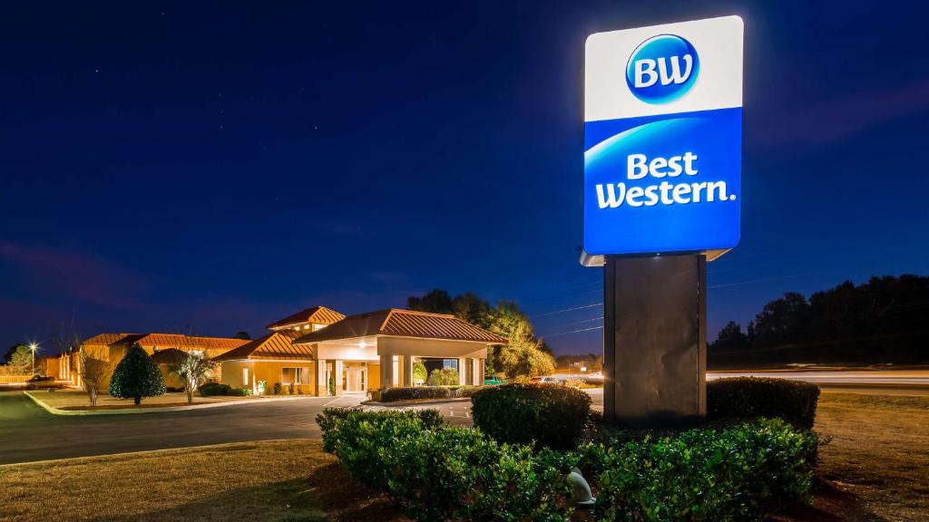 a best western sign in front of a house at Best Western Milton Inn in Milton