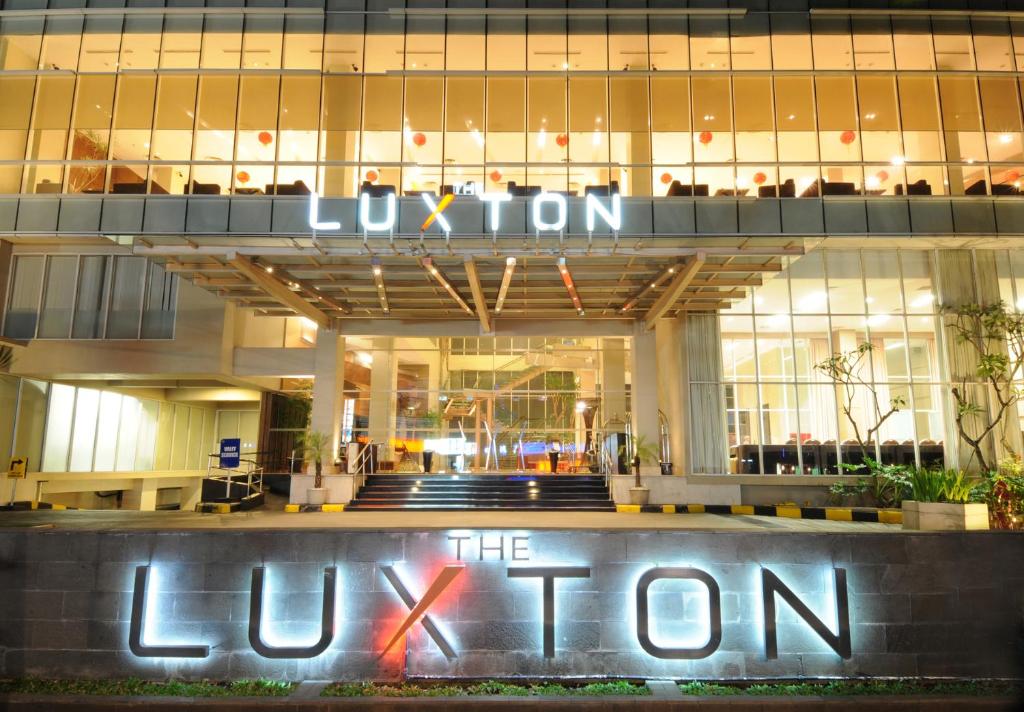 a lit up sign in front of a building at The Luxton Bandung in Bandung