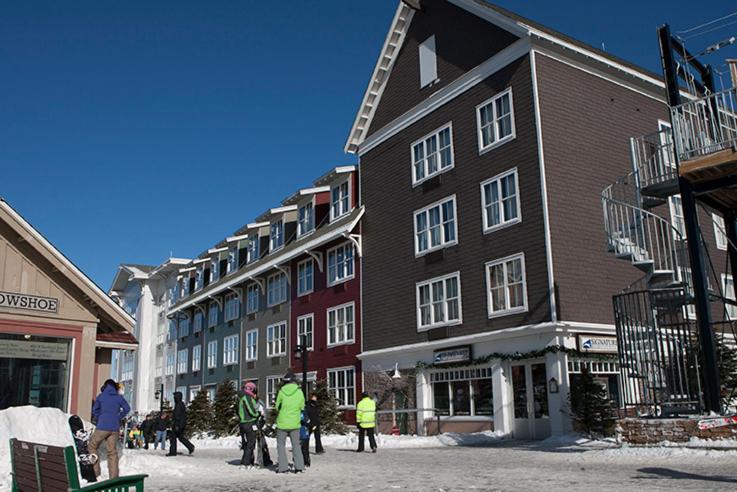 a group of people standing in front of a building at Expedition Station in Snowshoe