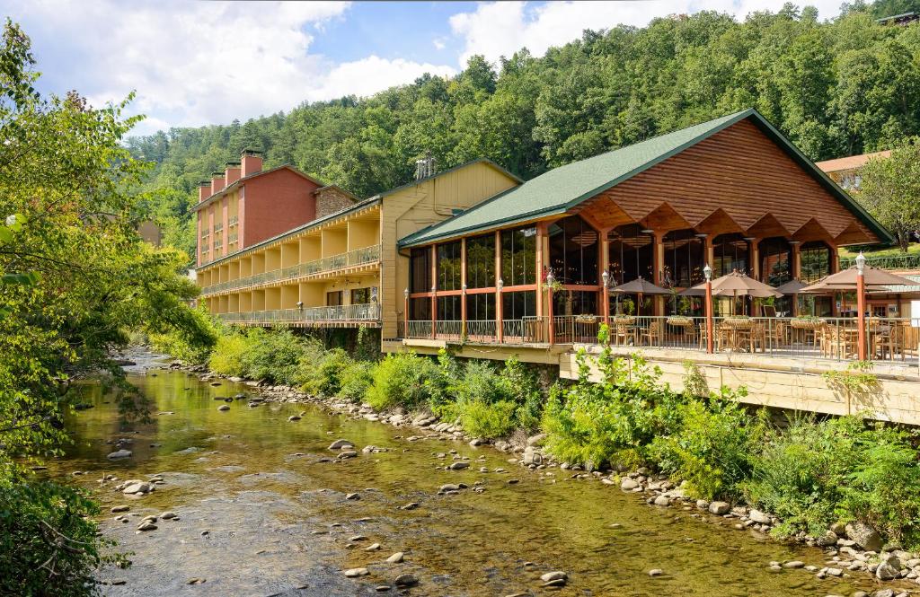 a hotel next to a river with a building at River Terrace Resort & Convention Center in Gatlinburg
