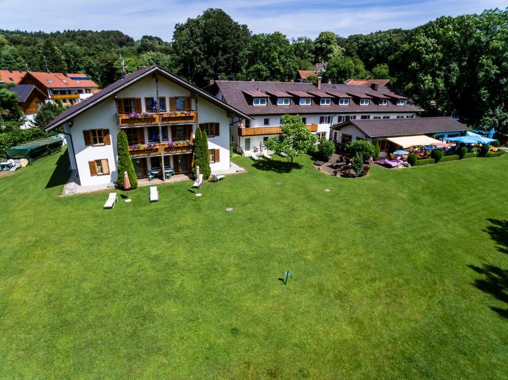 an aerial view of a house on a green field at Landhotel Huber am See in Münsing am Starnberger See