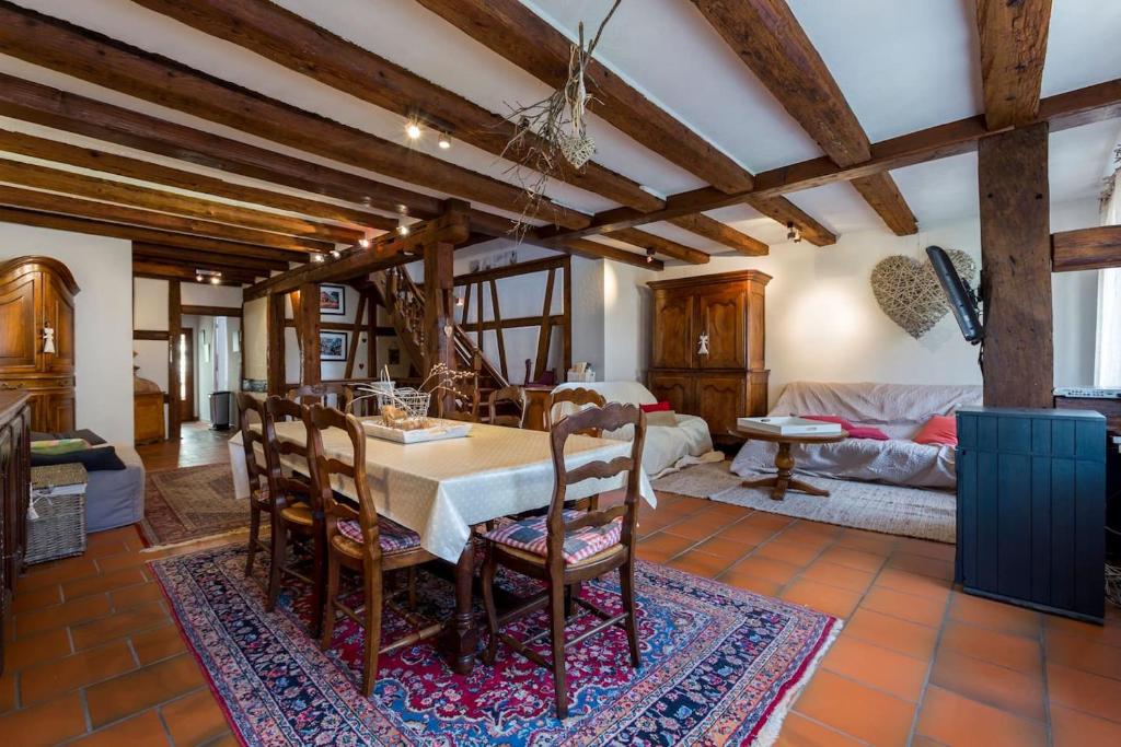 a kitchen and living room with a table and chairs at Gîte Manala in Kaysersberg