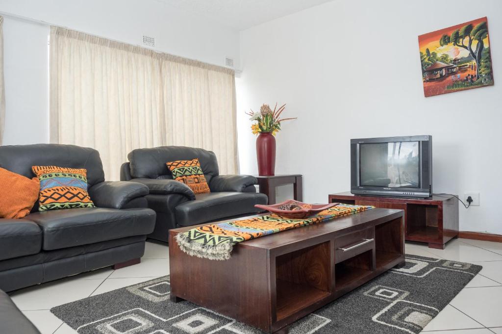 a living room with two couches and a tv at Arabella No. 1 in Margate