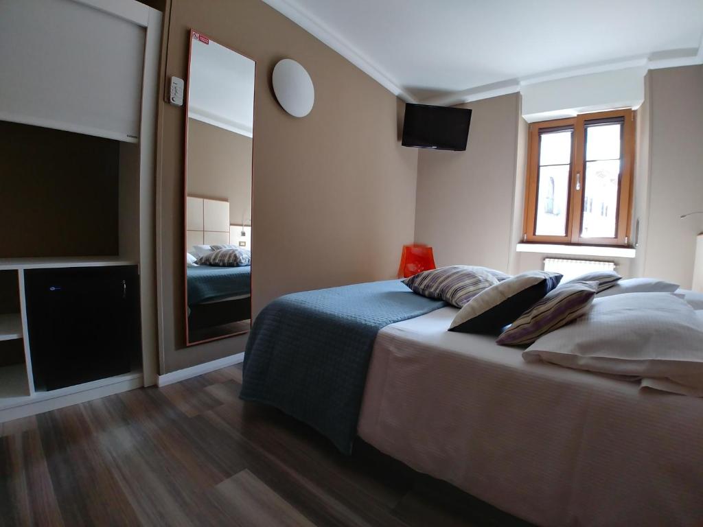 Postel nebo postele na pokoji v ubytování Albergo Aurora