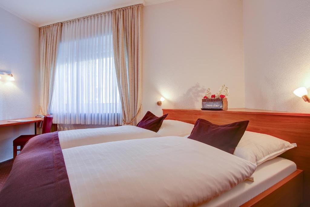 Postel nebo postele na pokoji v ubytování INA Hotel Consul