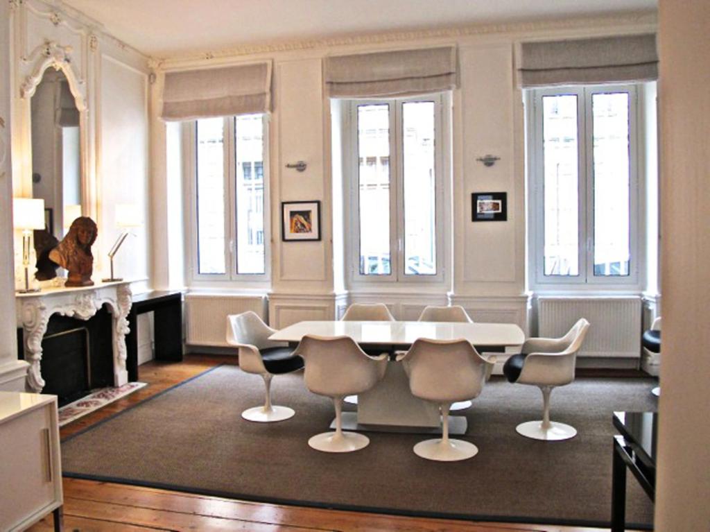 un salon avec une table et des chaises blanches dans l'établissement T3 HYPERCENTRE Jardin Public, à Bordeaux