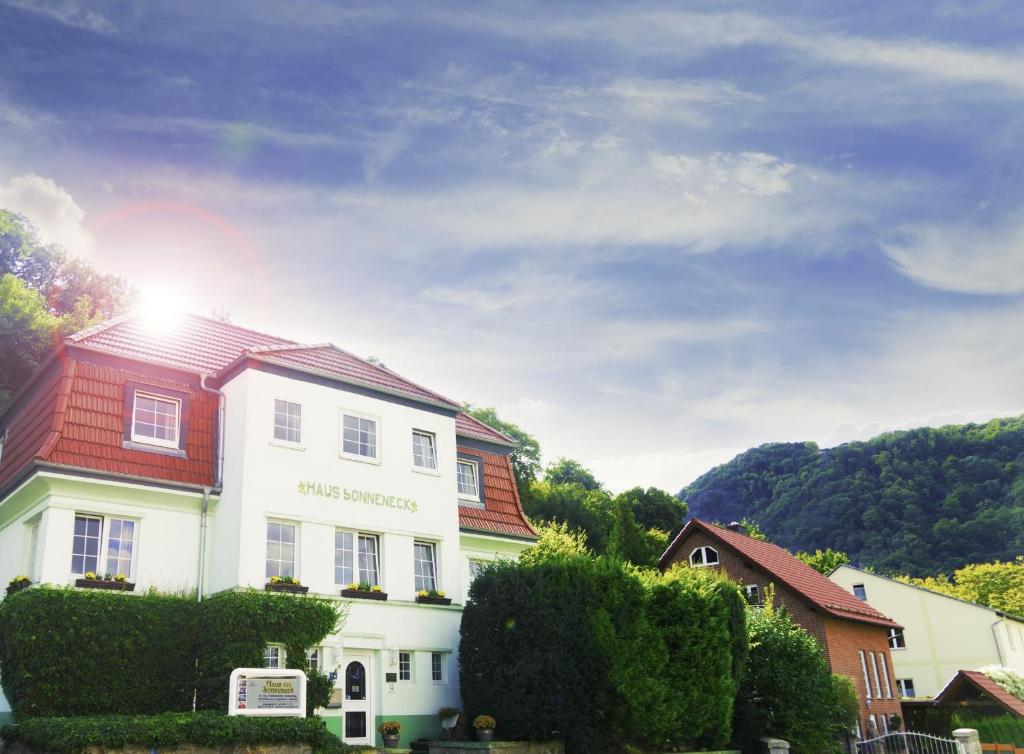 a white house with a red roof at Hotel Garni Haus Sonneneck in Thale