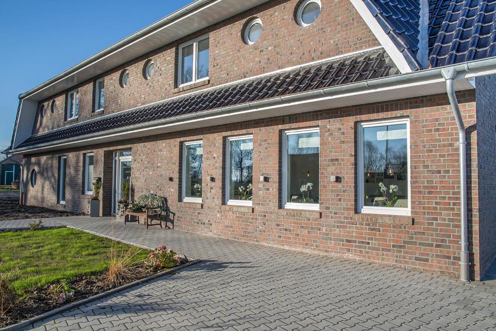 a brick building with a bench in front of it at Schmid's Landhaus in Werdum