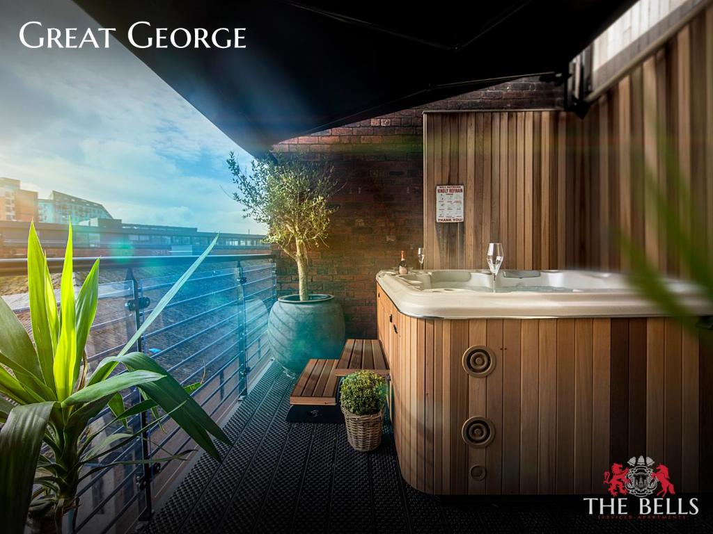 a bathroom with a sink and a balcony with plants at The Bells - Luxury Serviced Apartments in Leeds