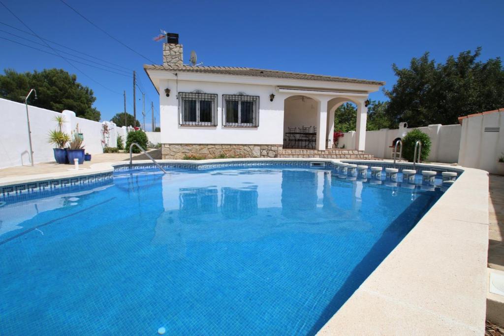 a swimming pool in front of a house at Villa Dorada in Montroig