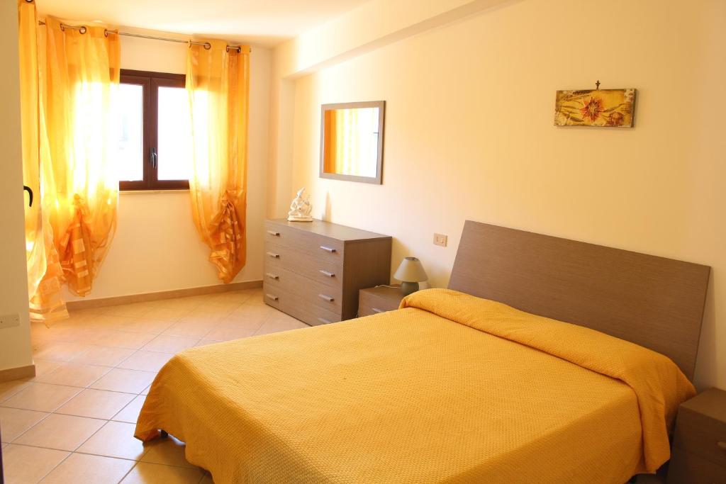 a bedroom with a bed and a dresser and a window at Case Vacanze Orlando Trappeto Summer in Trappeto