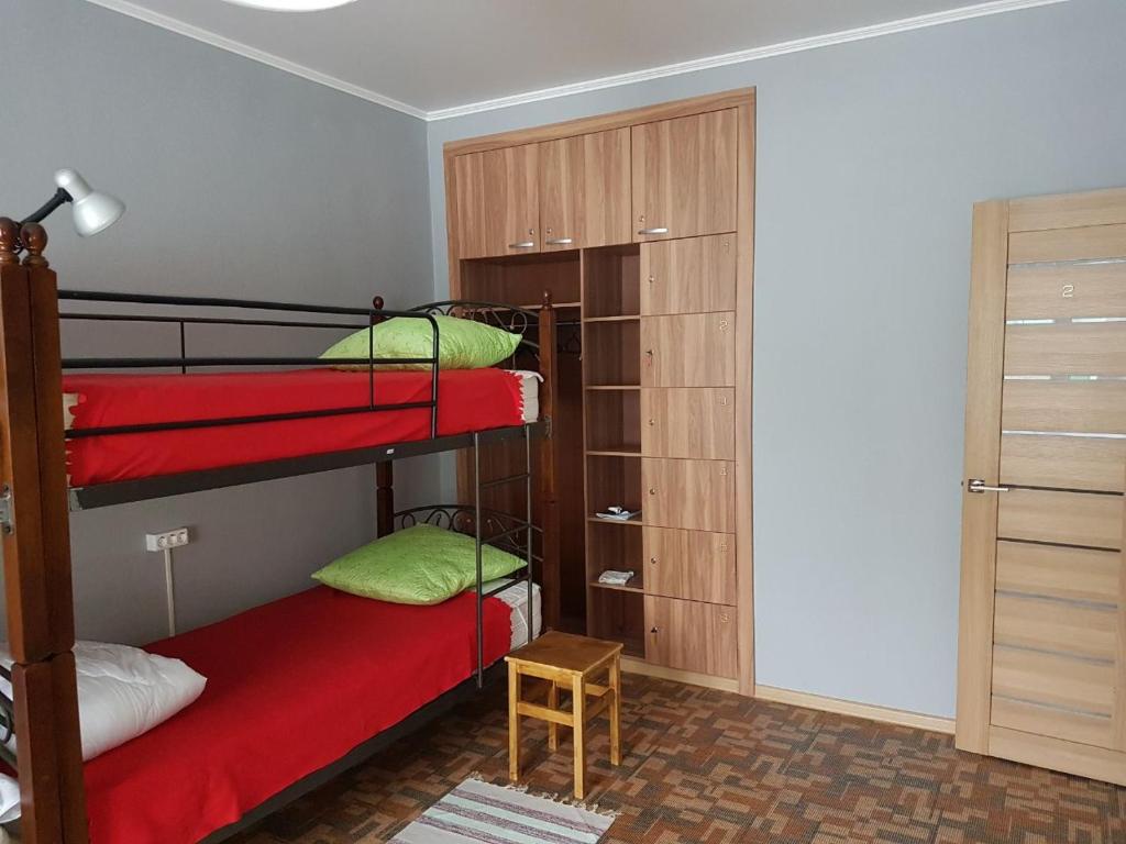 a bedroom with two bunk beds and a closet at Hostel 888 У Вокзала in Novosibirsk