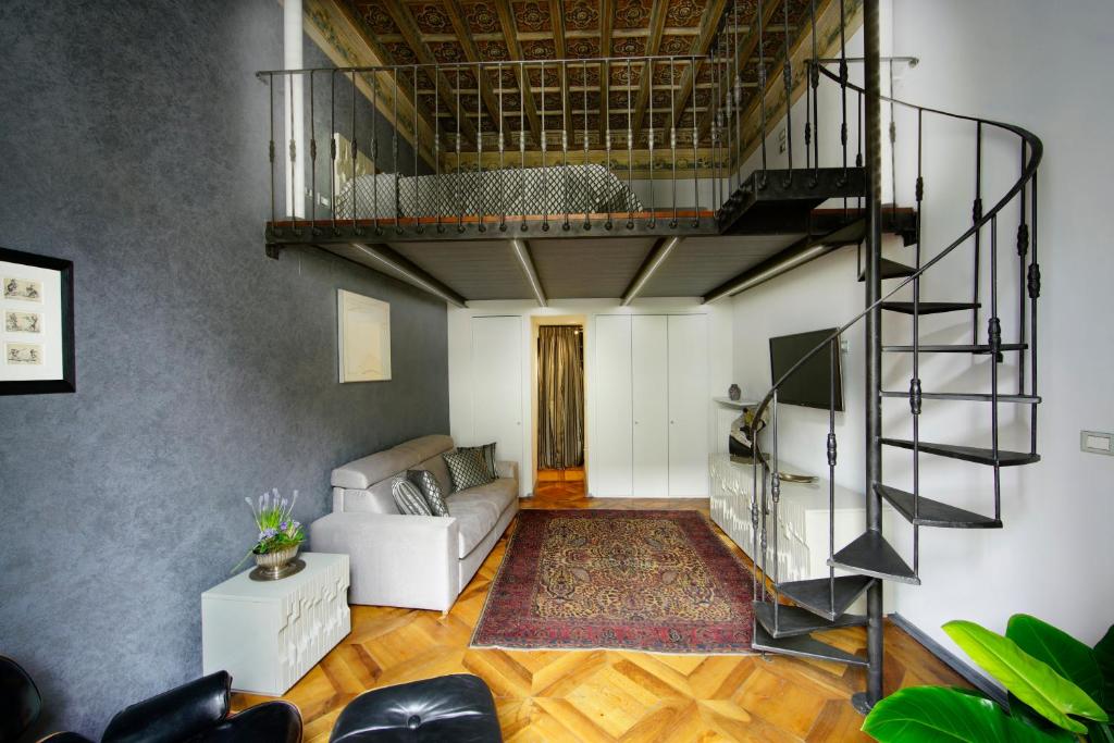 a living room with a staircase and a couch at Turin Art Experience in Turin