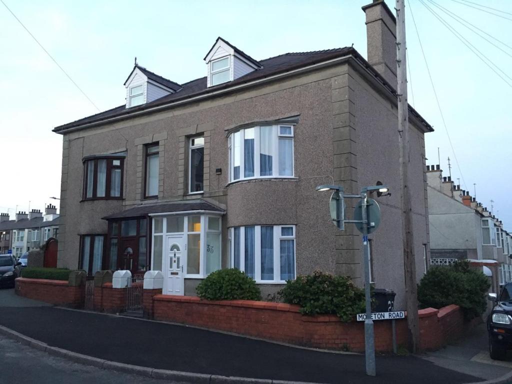 a brick house on the corner of a street at @33 Fab Townhouse in Holyhead