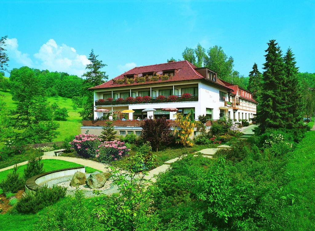a large house with a garden in front of it at Hotel Wiesengrund in Lindenfels