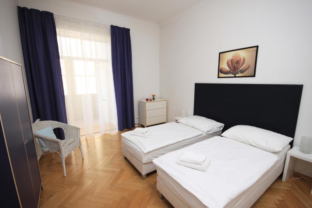 a hotel room with two beds and a window at Old Town Apartments in Prague