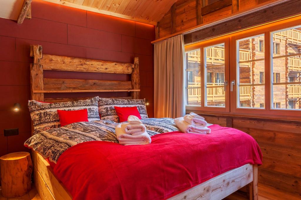 two people laying on a bed in a room at Schirle in Zermatt