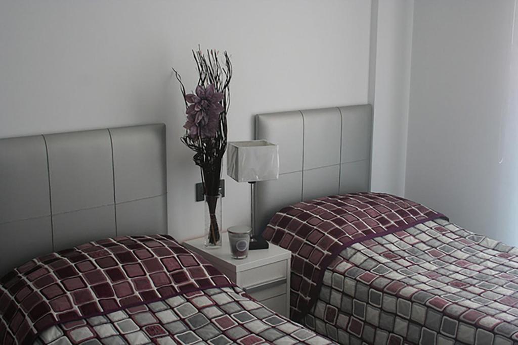 Postel nebo postele na pokoji v ubytování OasisBeach Penthousse la Zénia