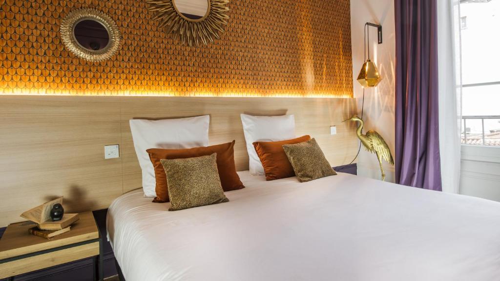Postel nebo postele na pokoji v ubytování MiHotel Gailleton