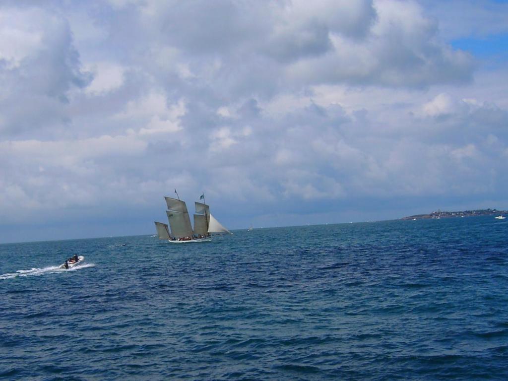 two boats in the water with a sail boat at L'escale Granvillaise in Granville
