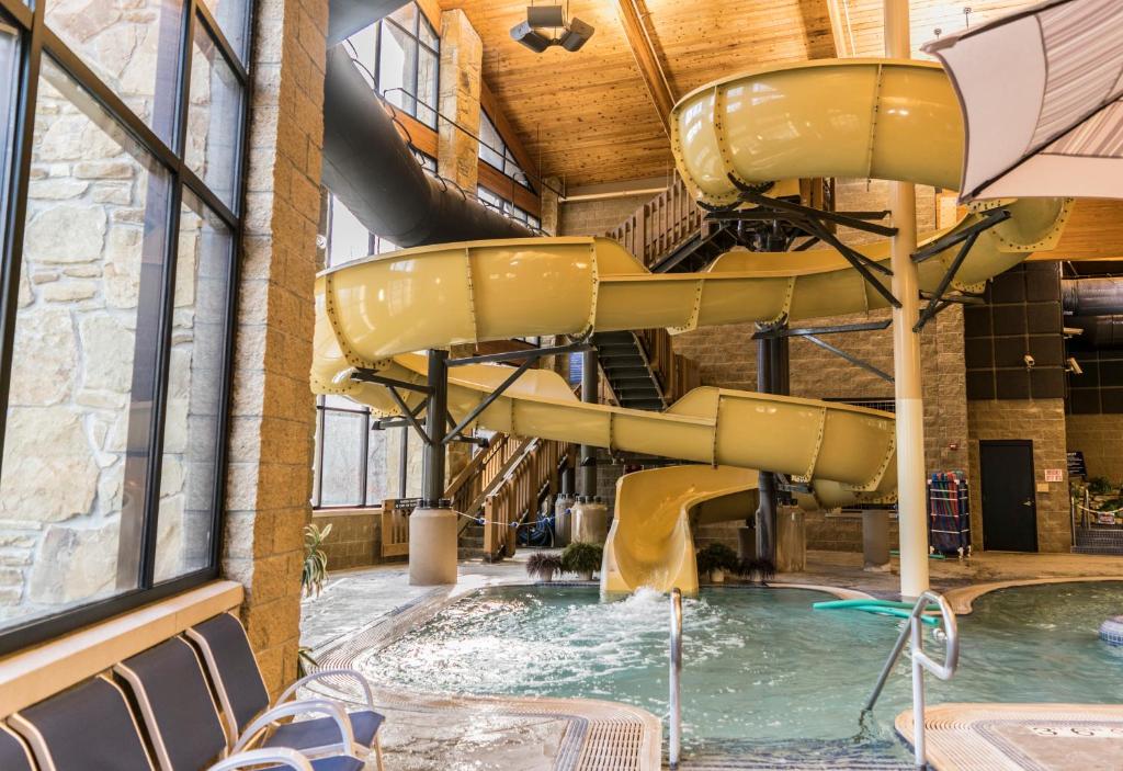 a large indoor pool with a slide in a building at Abe Martin Lodge & Cabins in Nashville