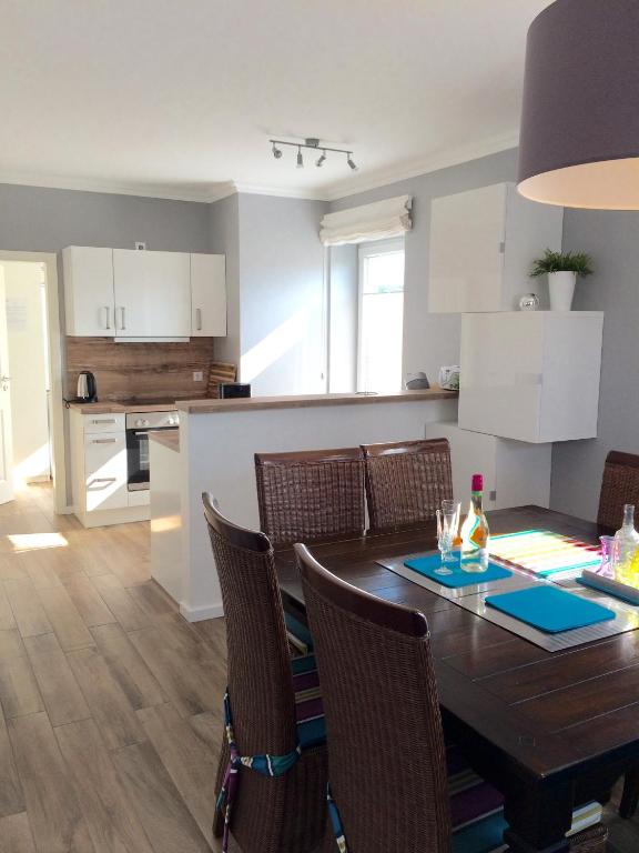 a kitchen and dining room with a table and chairs at Ferienhaus Strandgut in Petersfeld