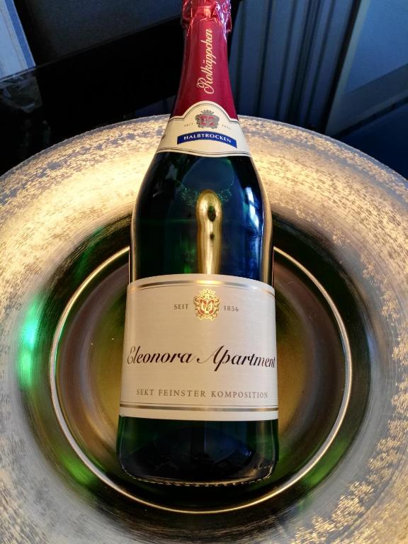 a bottle of wine sitting on a plate at Eleonora Apartment in Winterberg