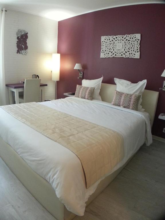 Postel nebo postele na pokoji v ubytování Hôtel Beausoleil