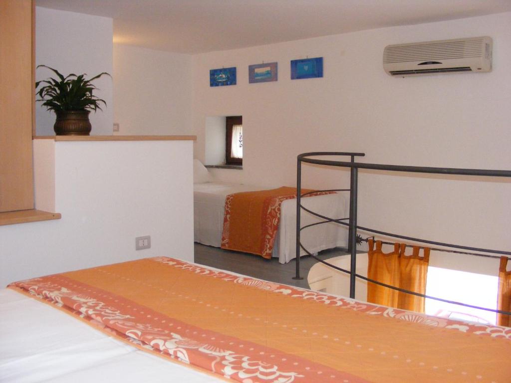 a hotel room with a bed and a tv at Casa Mafalda B&B in Lipari